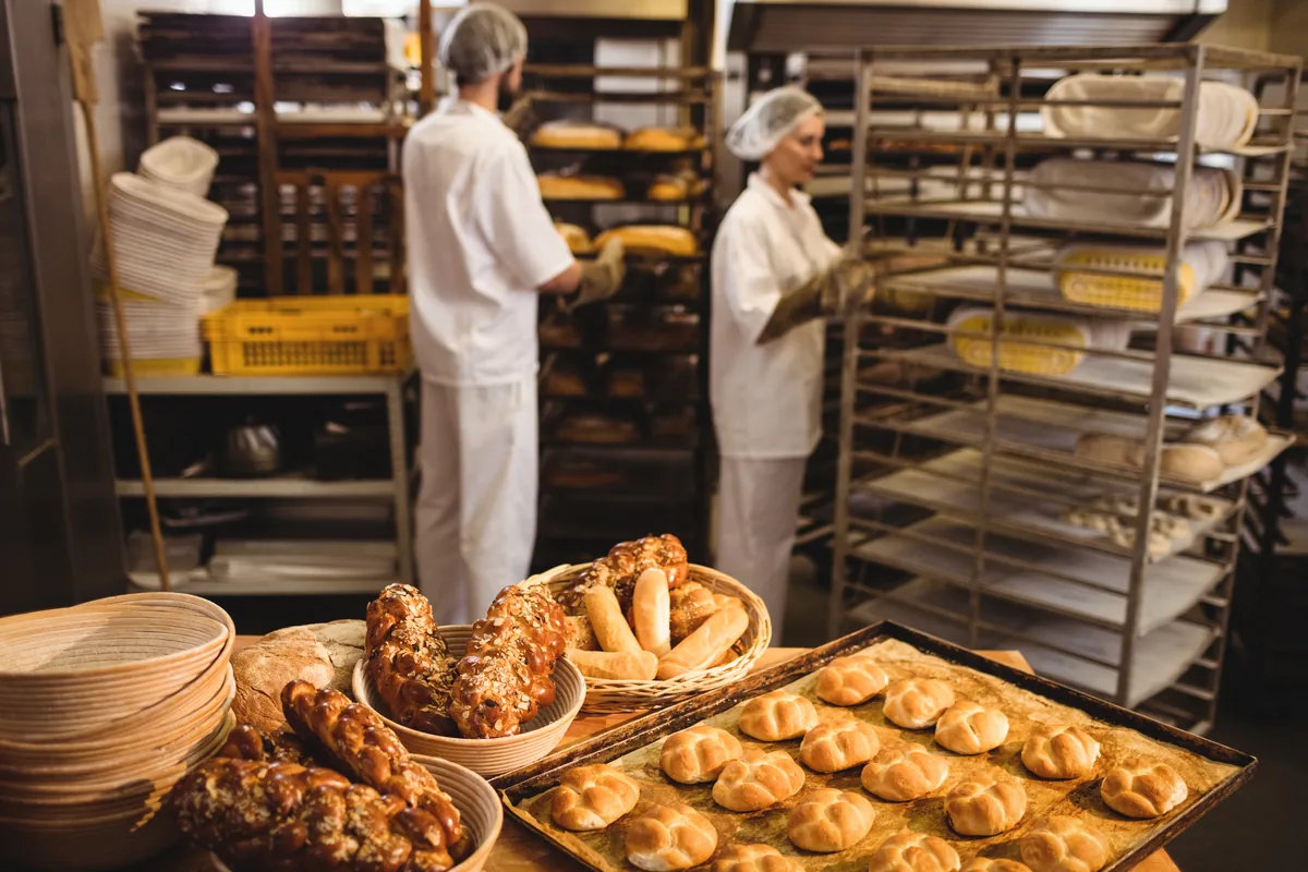 Fresh bread and baked goods being prepared in a working bakery