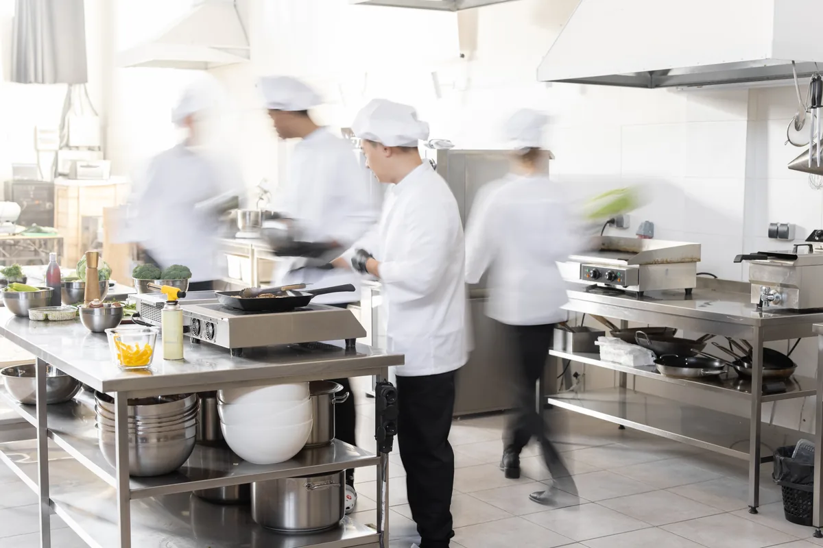 Chefs at work preparing food in a commercial kitchen